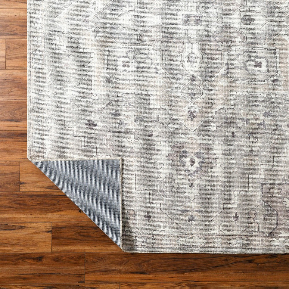 brown traditional rug corner folded on wood floor