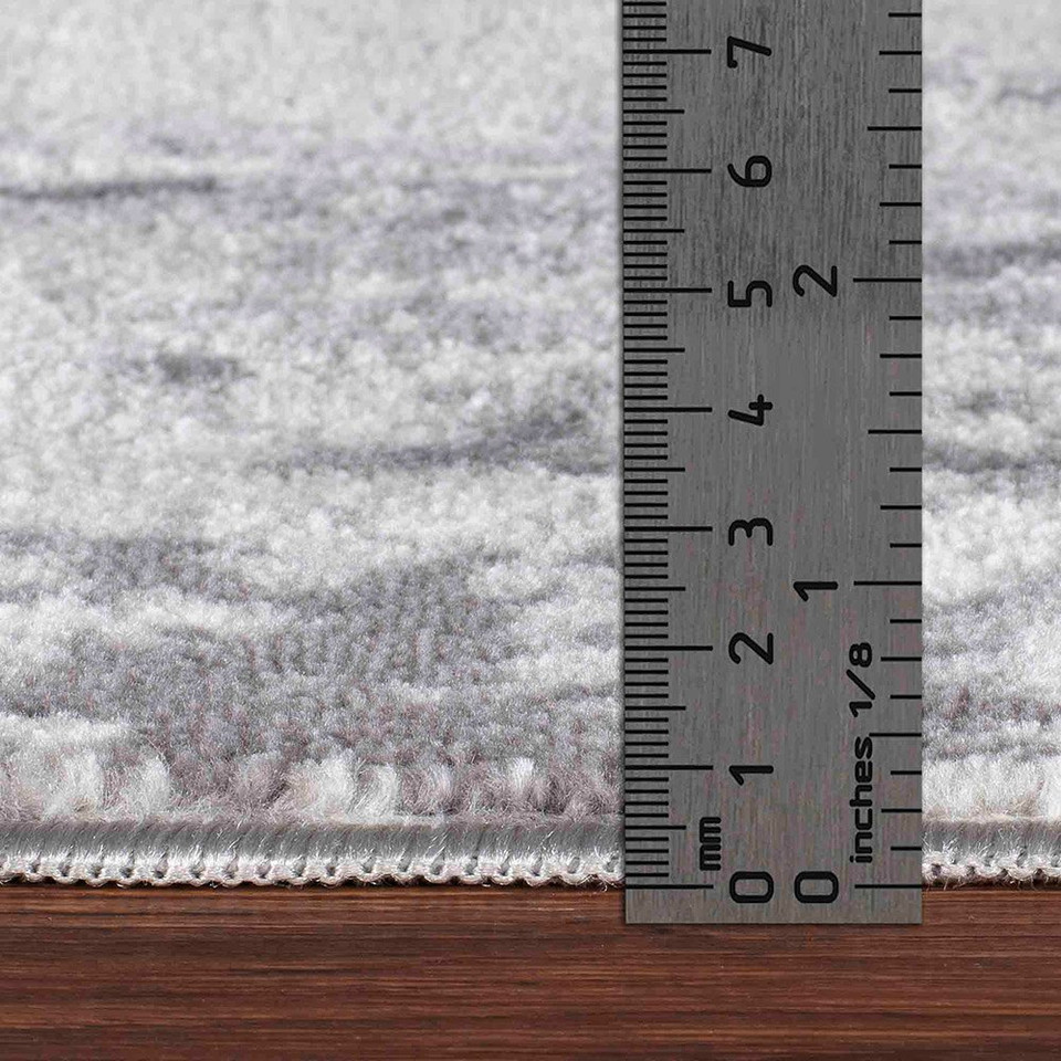 grey abstract rug pile height on wood floor