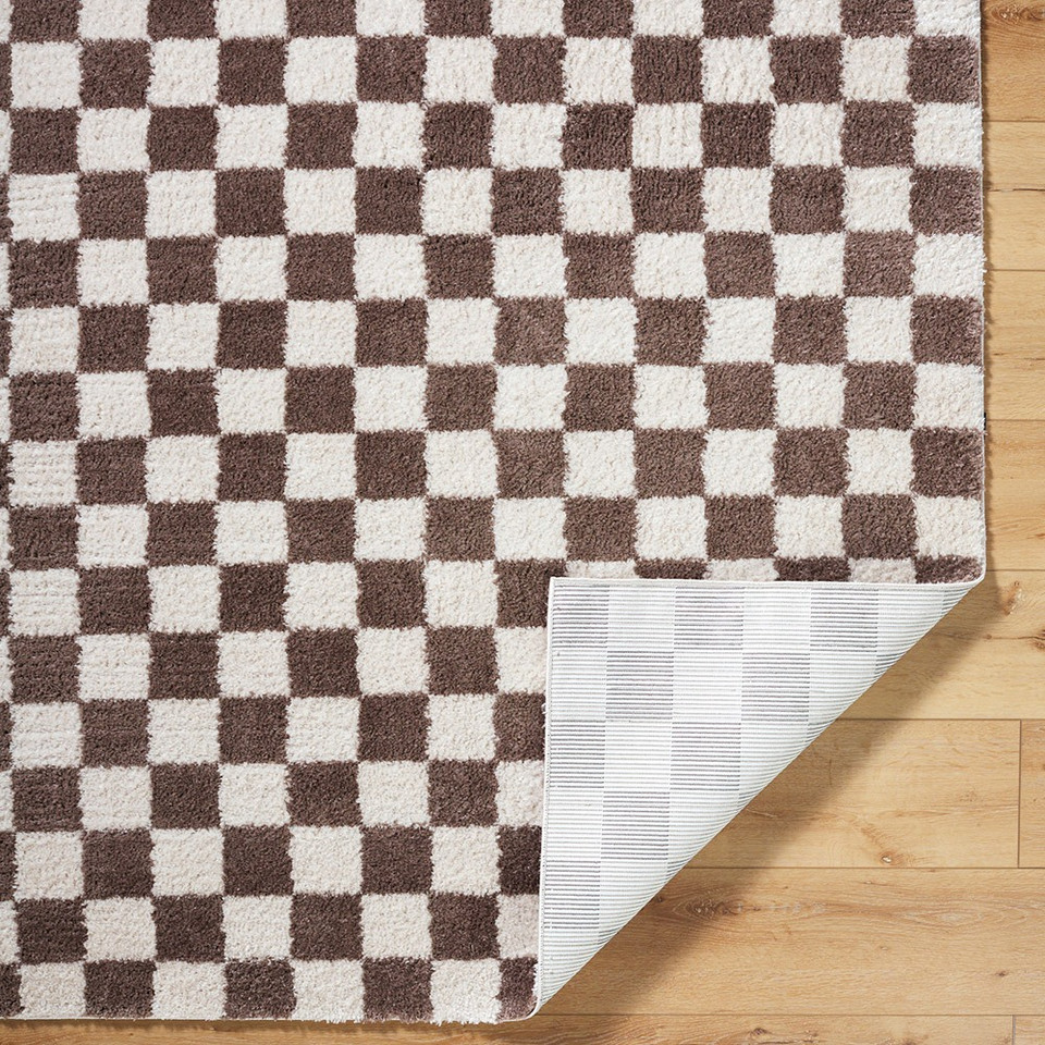 brown checker shaggy rug folded on wood floor