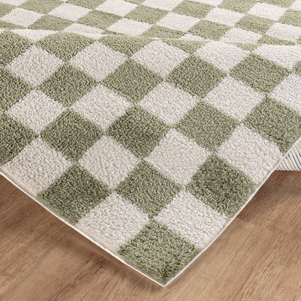 green checker shaggy rug folded on wood floor