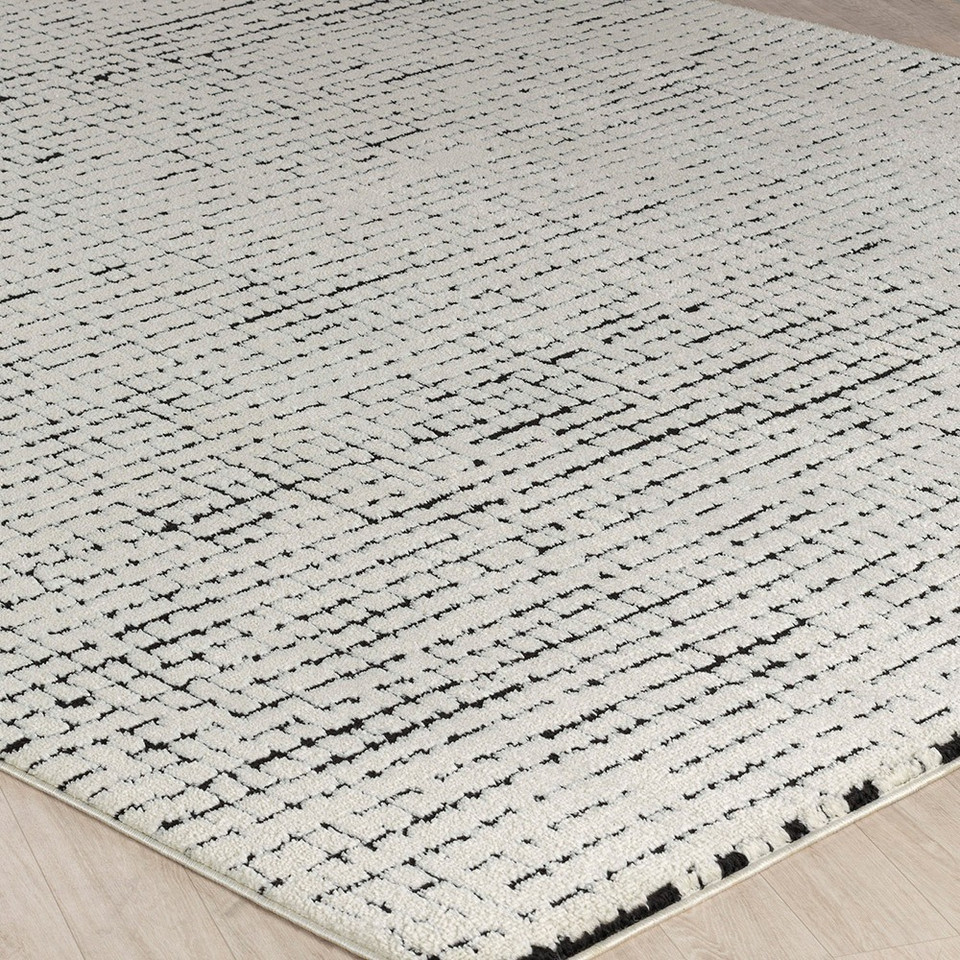 ivory black scandi rug closeup corner on wood floor