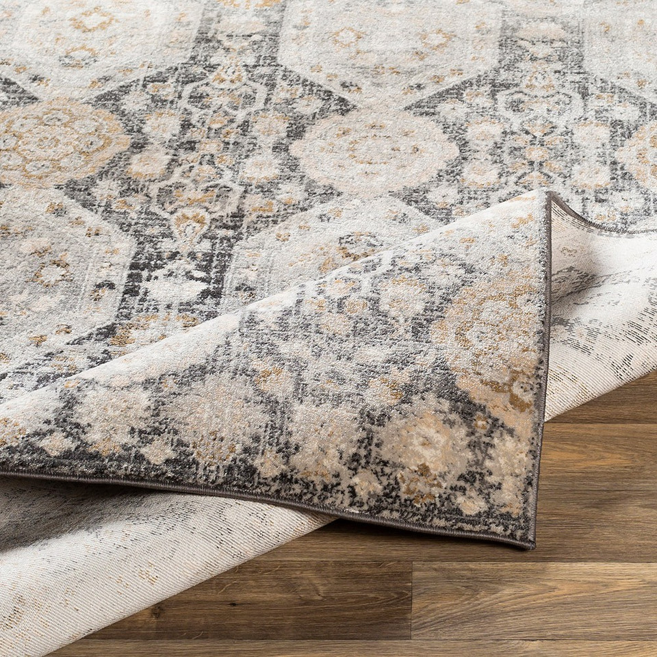 black traditional rug folded on wood floor
