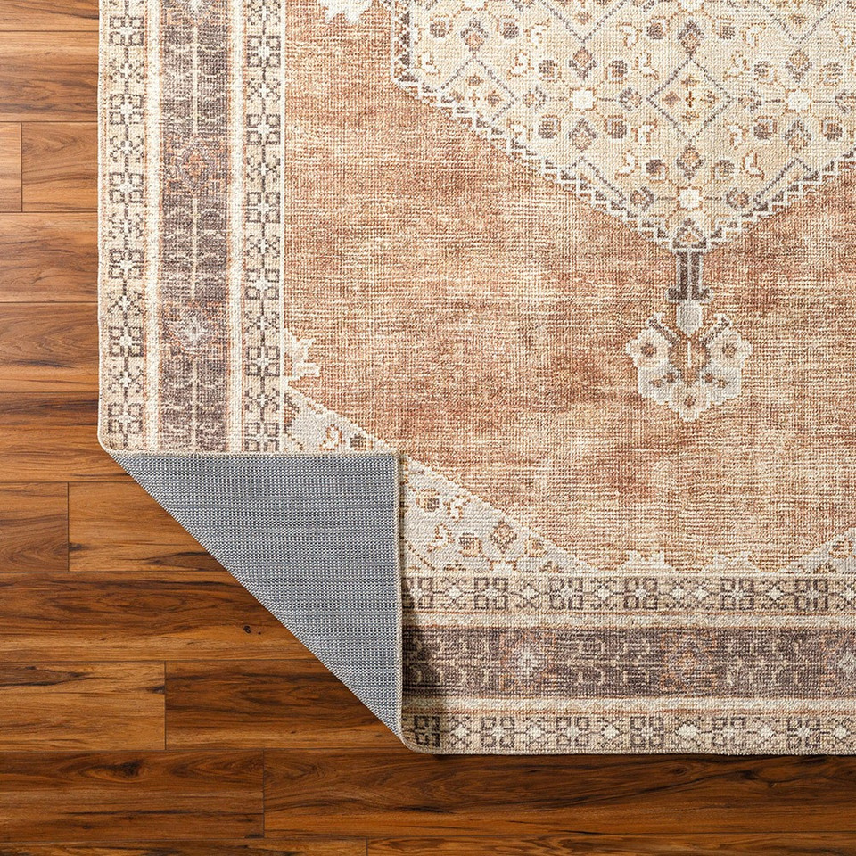 cinnamon traditional rug folded on wood floor