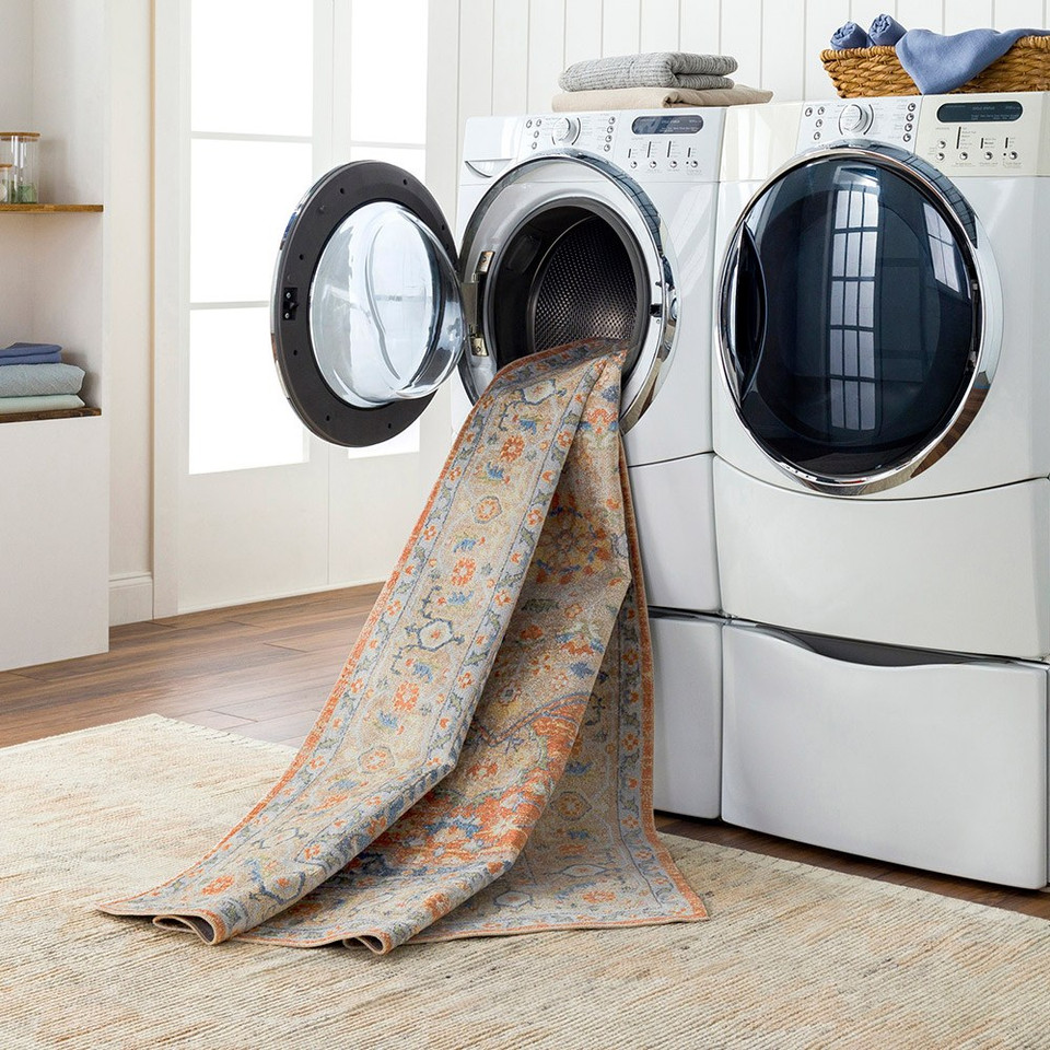 orange traditional rug in a washing machine