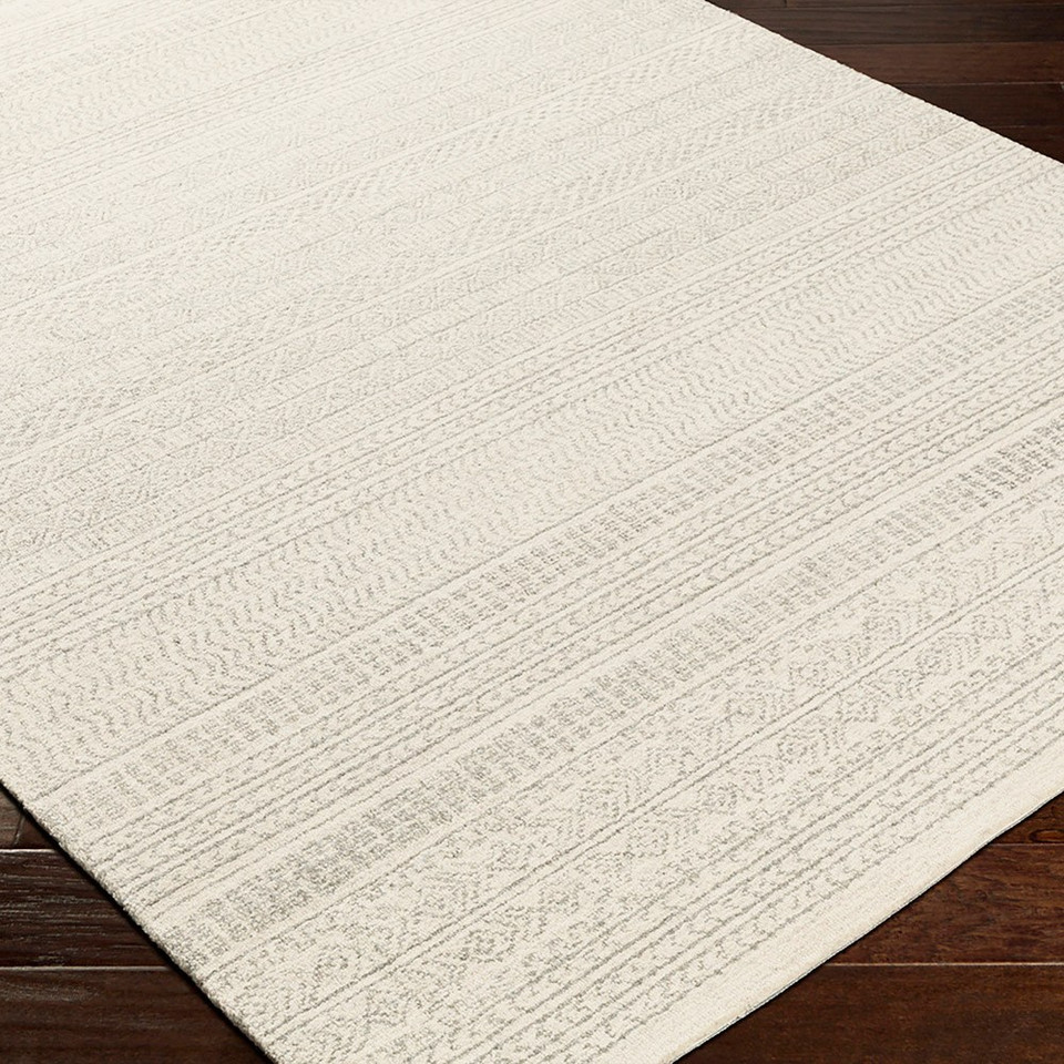 grey tribal wool rug closeup corner on wood floor