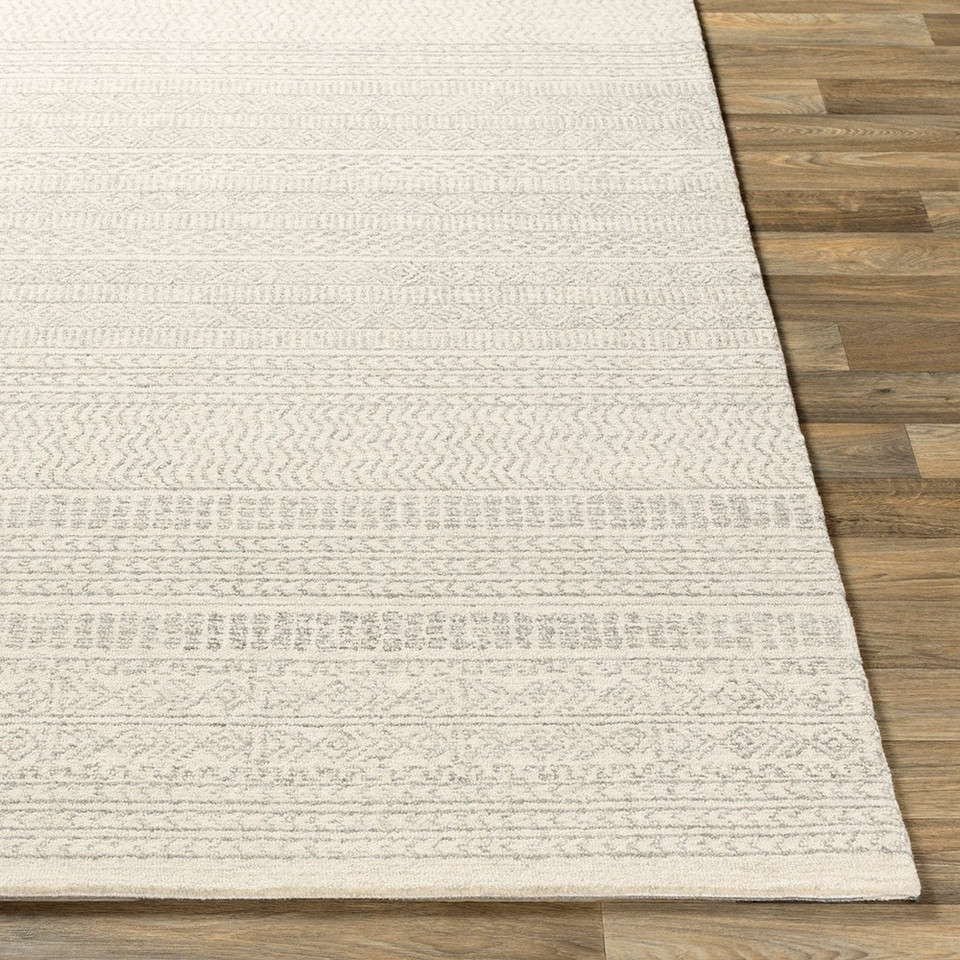 grey tribal wool rug closeup corner on wood floor