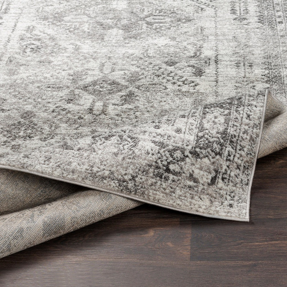 grey abstract rug closeup folded on wood floor