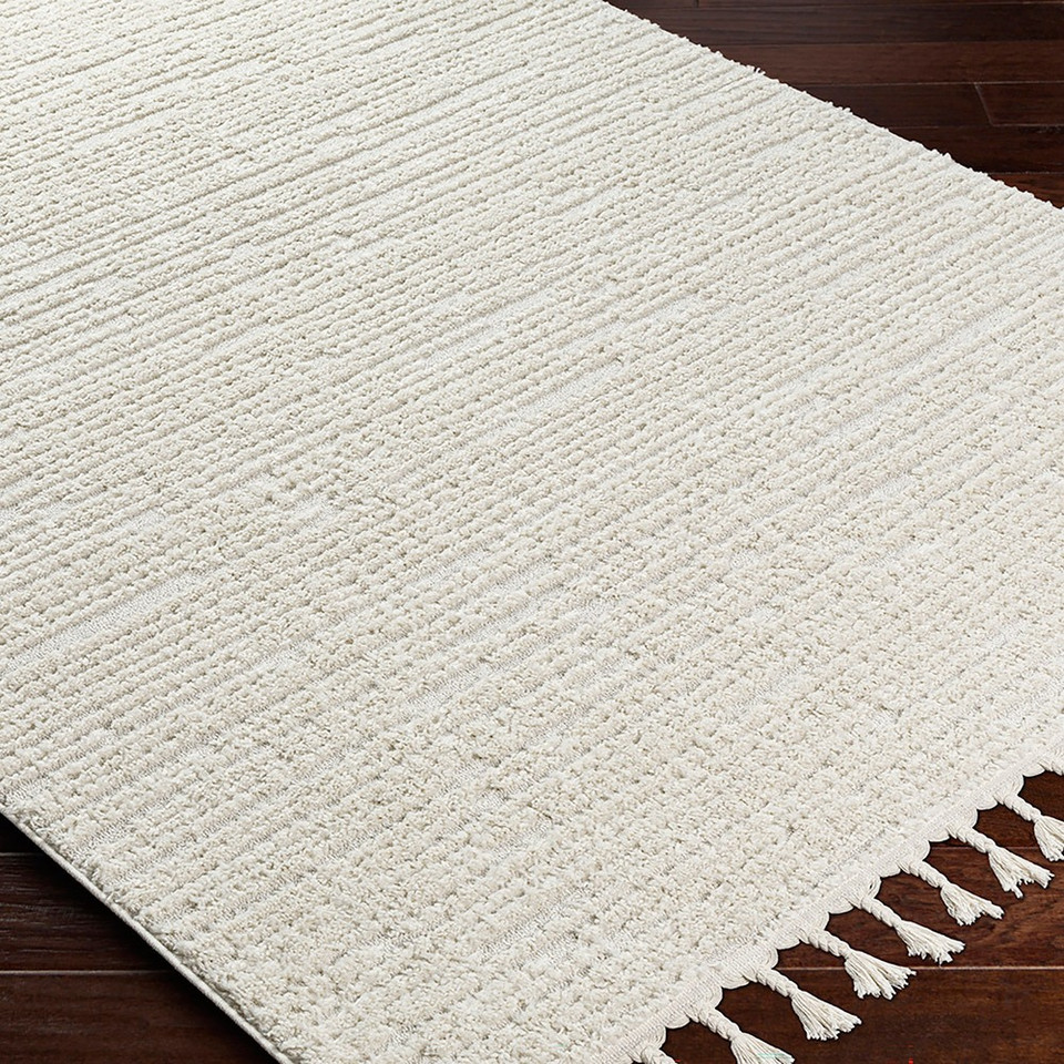 ivory berber geometric rug closeup corner on wood floor