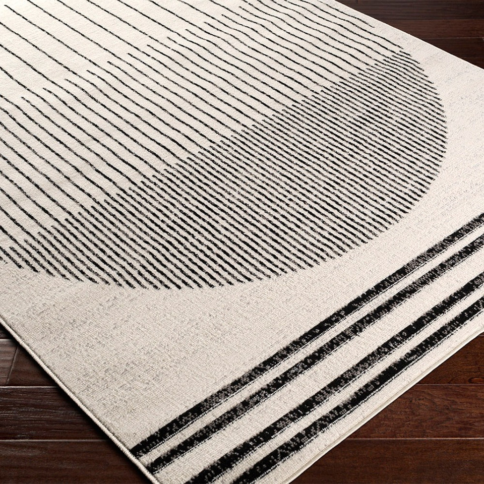 mono geometric rug closeup corner on wood floor