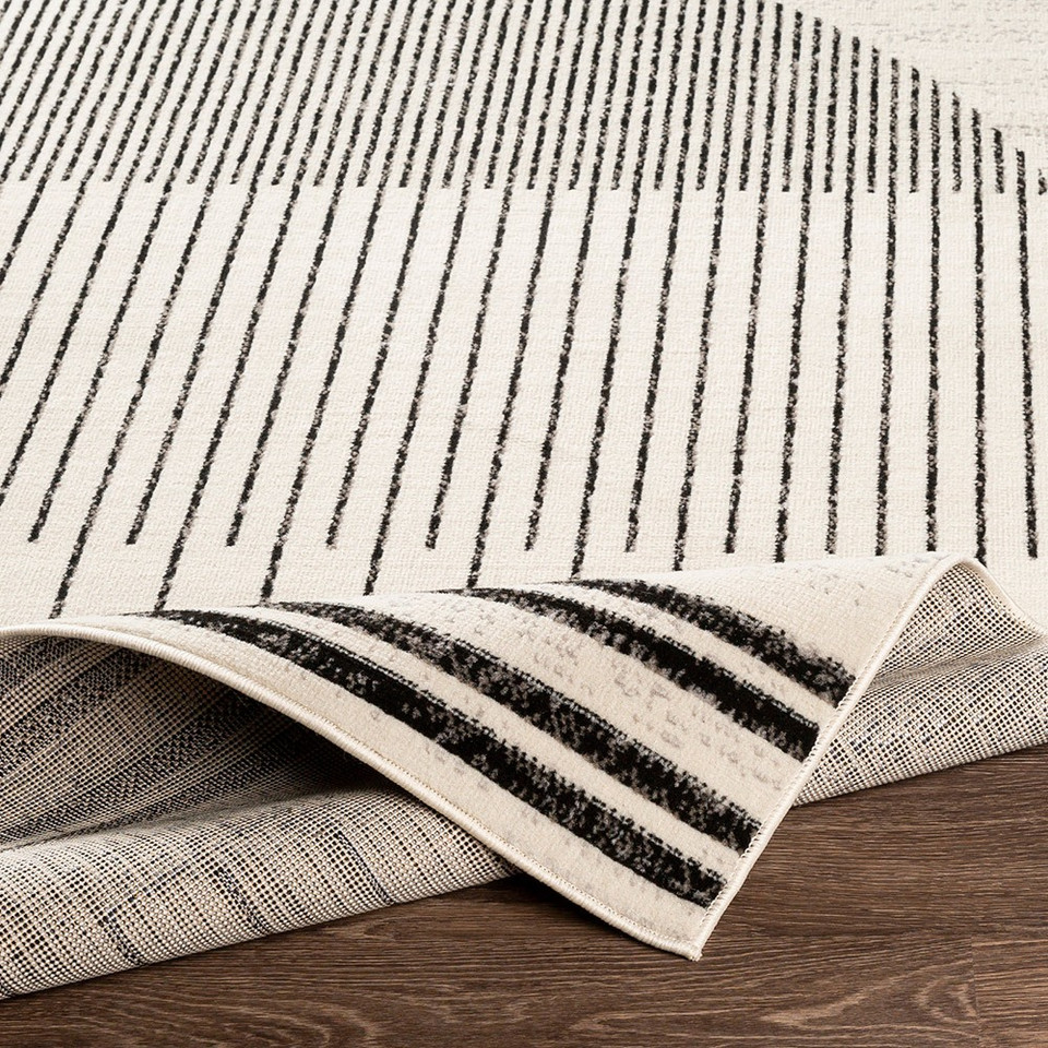 mono geometric rug corner fold on wood floor