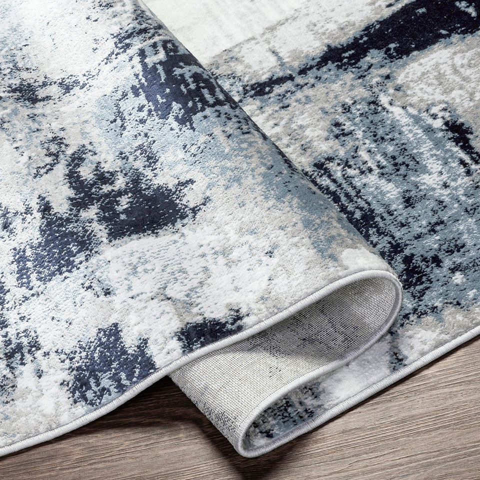 navy abstract rug corner fold on wood floor