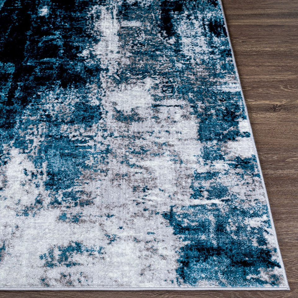 teal abstract rug closeup corner on wood floor