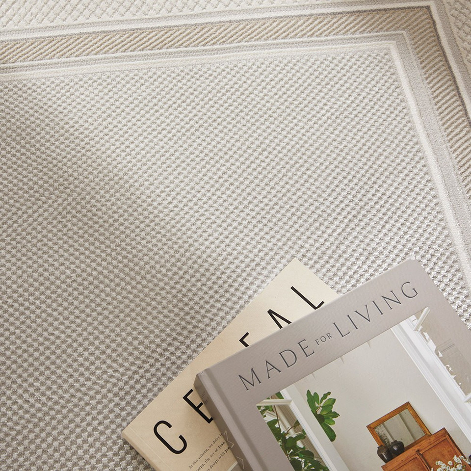 grey beige modern rug closeup with books