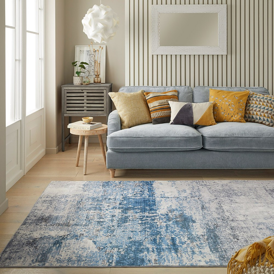 ivory blue abstract rug in a living room with matching decor