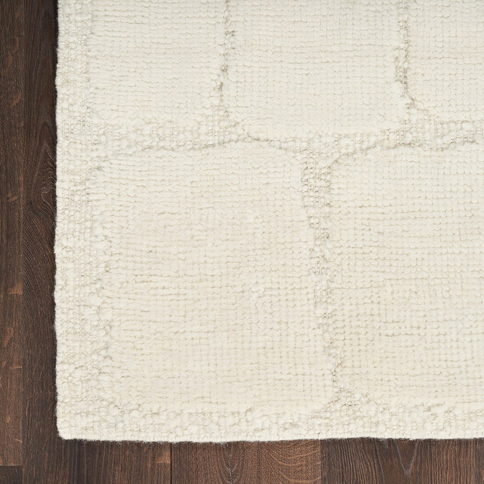 ivory wool rug closeup corner on wood floor