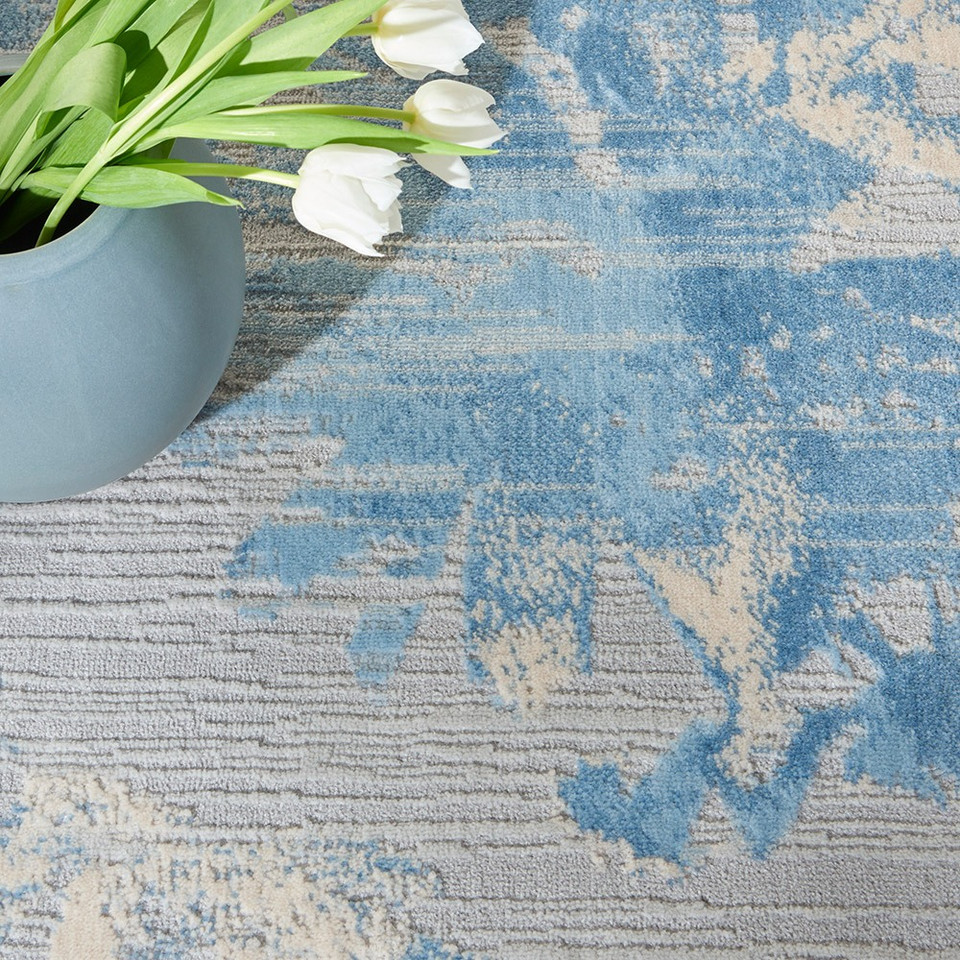 grey sky calvin klein rug closeup with a plant pot