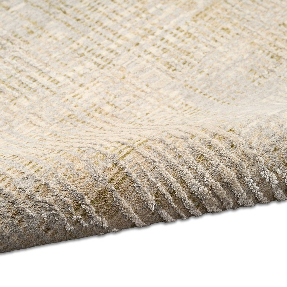 grey calvin klein rug partially rolled on white floor