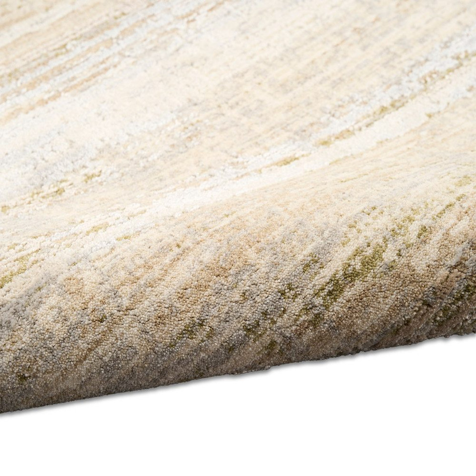 sand calvin klein rug partially rolled on white floor