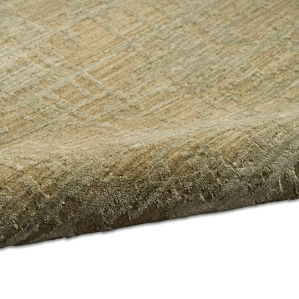 green calvin klein rug partially rolled on white floor