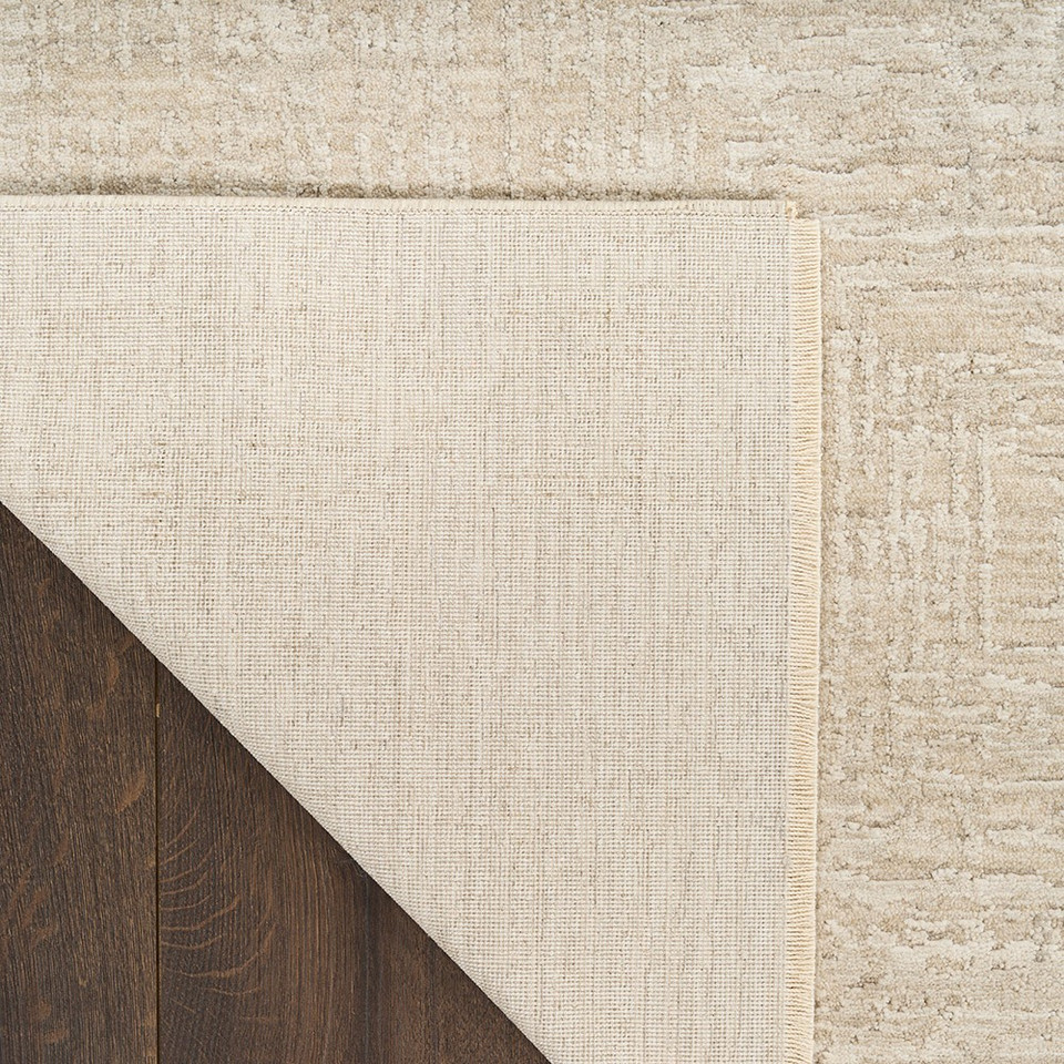 ivory beige abstract rug closeup folded on white background