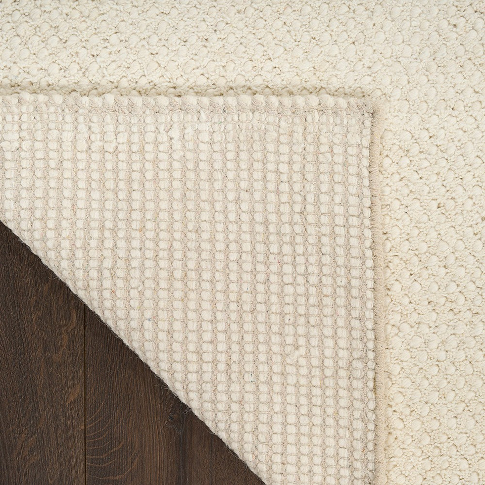 ivory rug closeup folded on white background