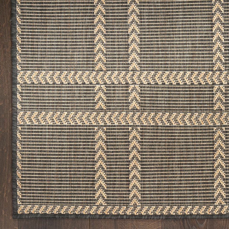 charcoal geometric indoor outdoor rug closeup corner on wood floor