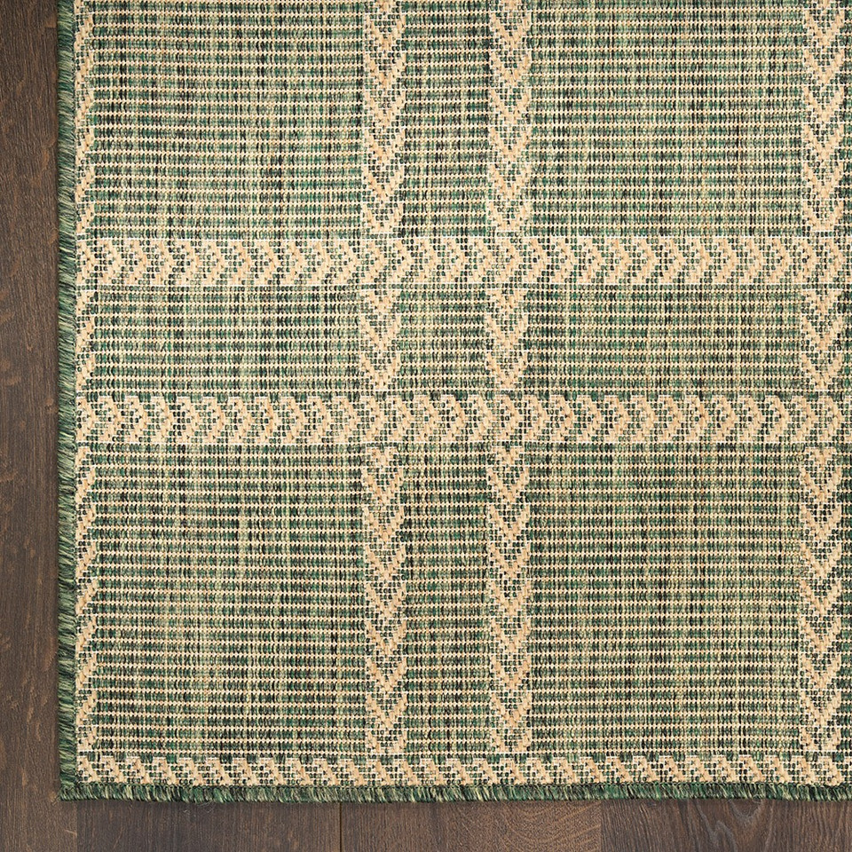 green geometric indoor outdoor rug closeup corner on wood floor