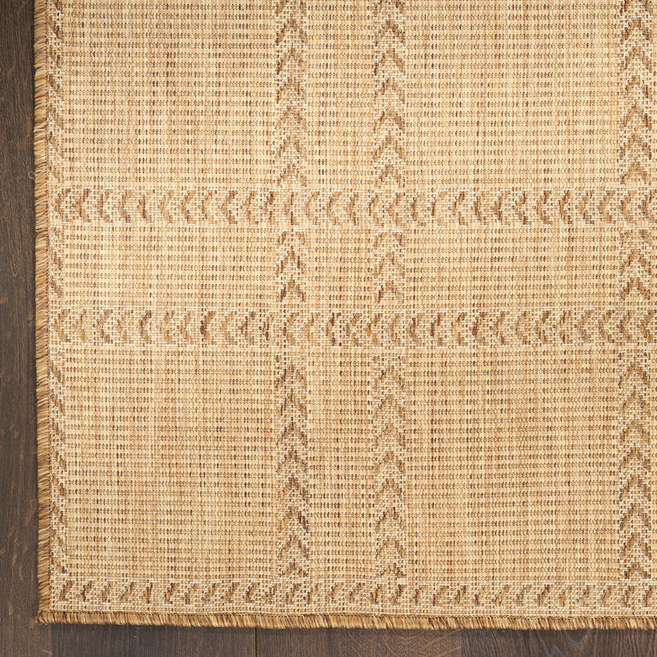 natural geometric indoor outdoor rug closeup corner on wood floor