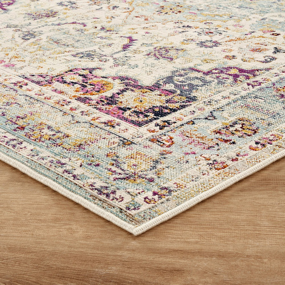 blue gold traditional rug closeup corner on wood floor