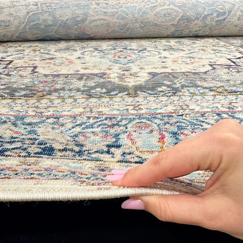ivory traditional rug closeup edge on wood floor showing pile thickness