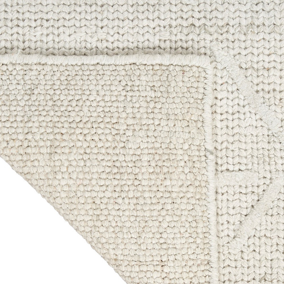 grey ivory calvin klein rug corner fold on white background