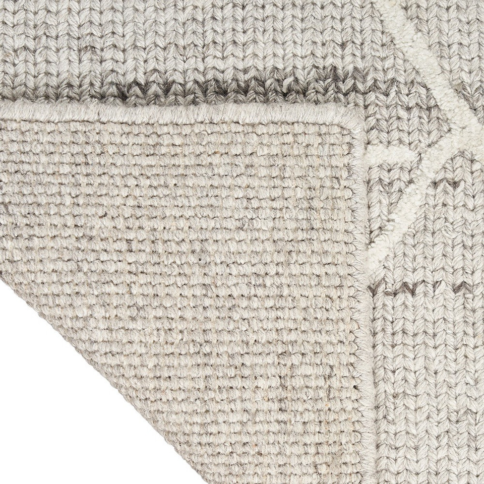 grey calvin klein rug corner fold on white background