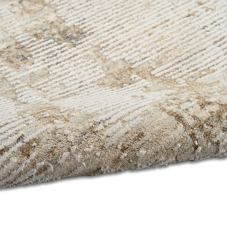 natural grey calvin klein rug partially rolled on white floor