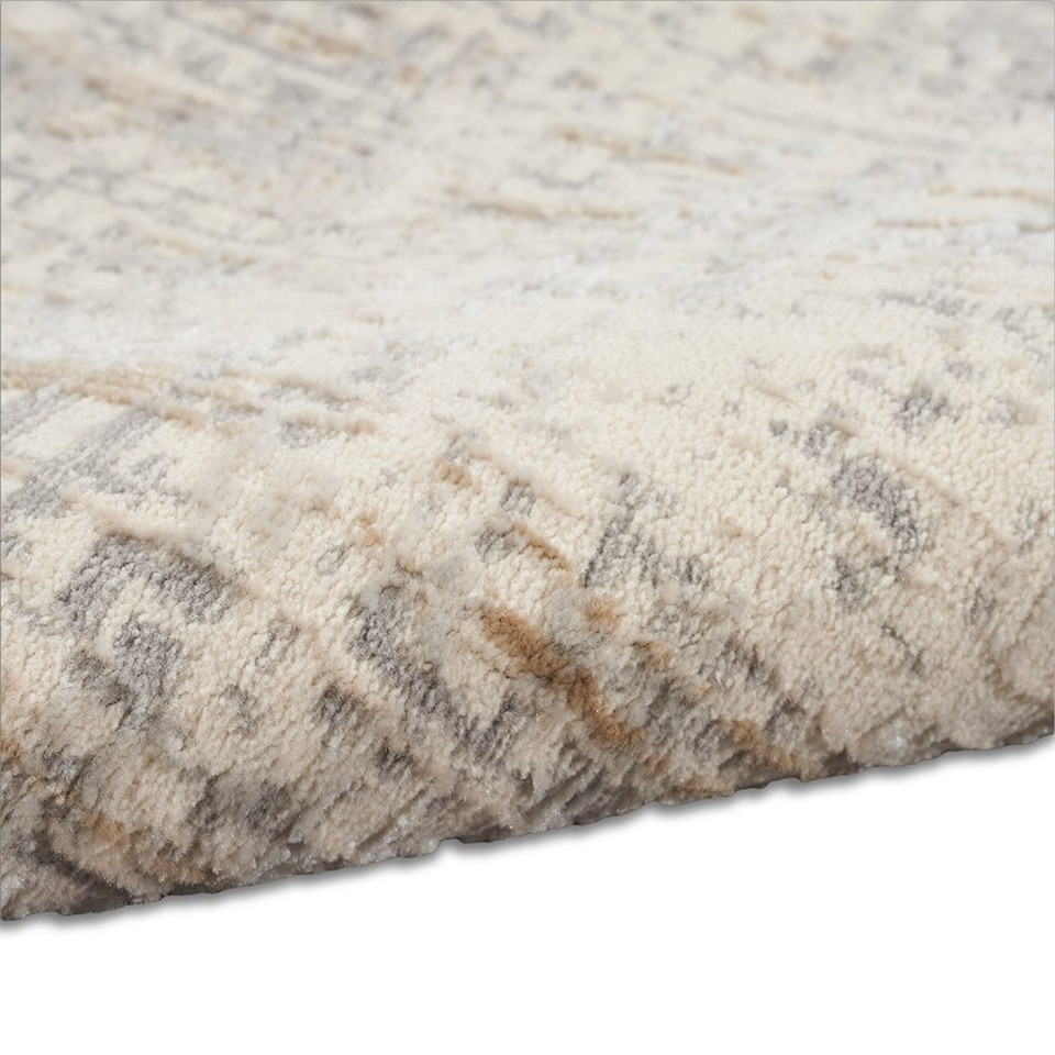 grey calvin klein rug partially rolled on white floor