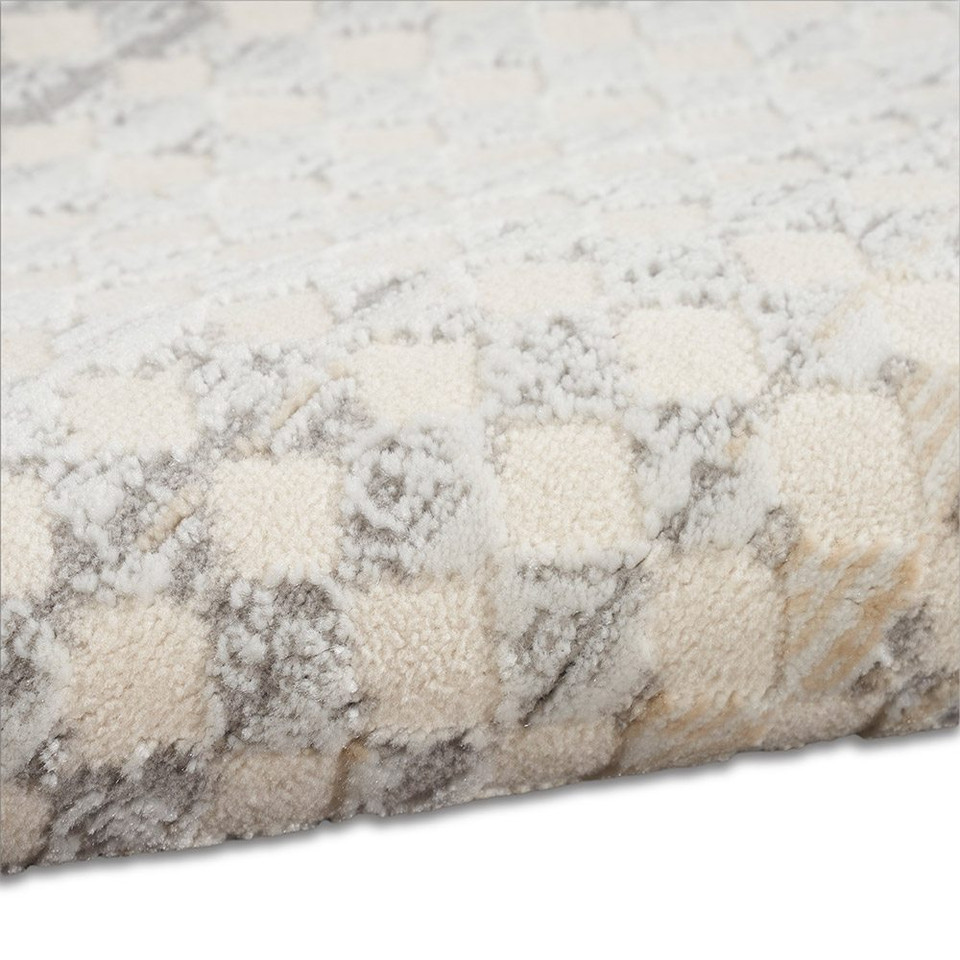 ivory multi calvin klein rug partially rolled on white floor