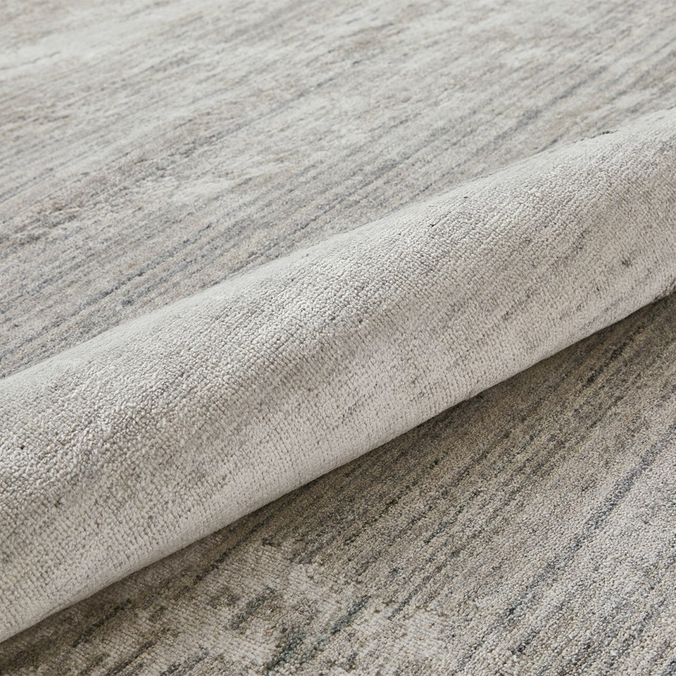 white blue abstract rug closeup partially rolled