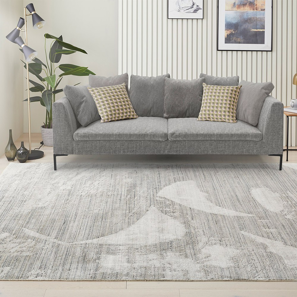 white blue abstract rug in a living room with matching decor