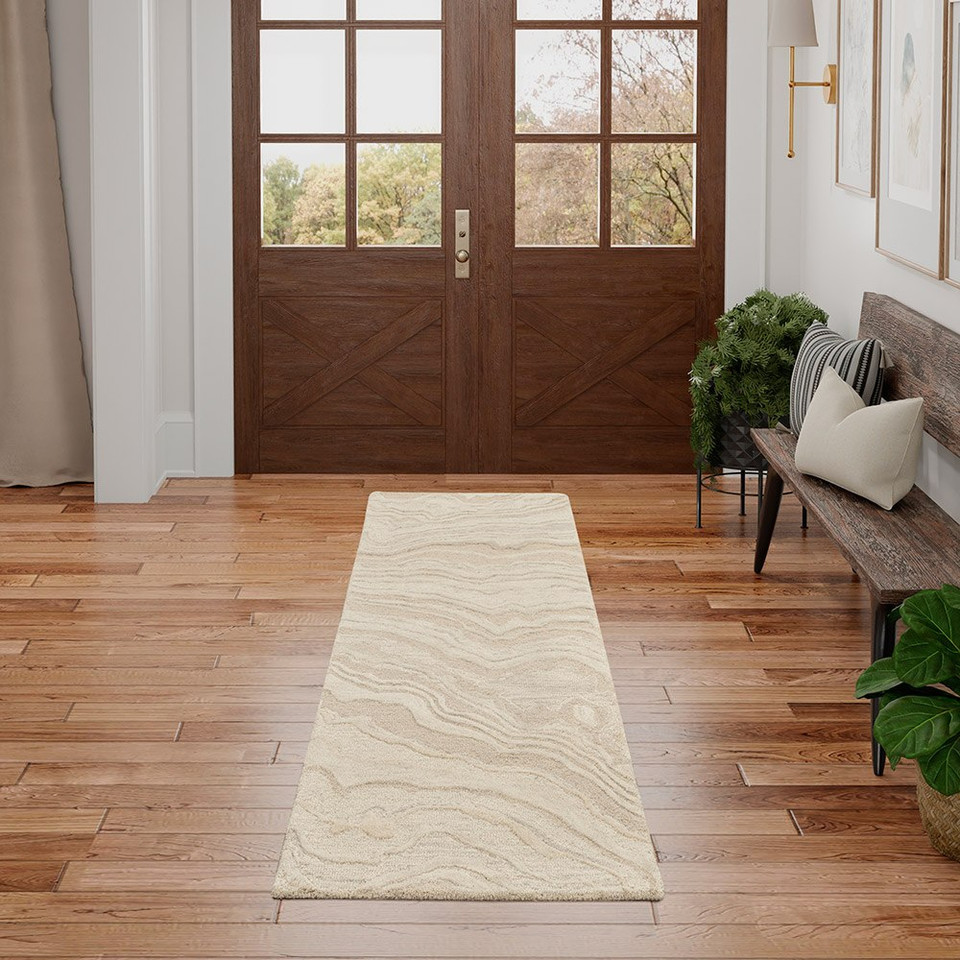 beige abstract rug in a room with matching decor