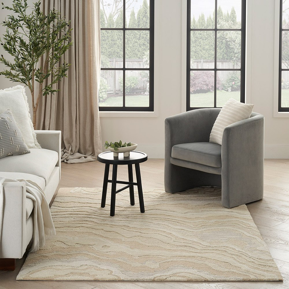 beige abstract rug in a room with matching decor