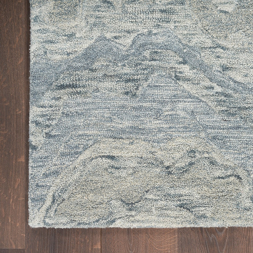 blue abstract rug closeup corner on wood floor