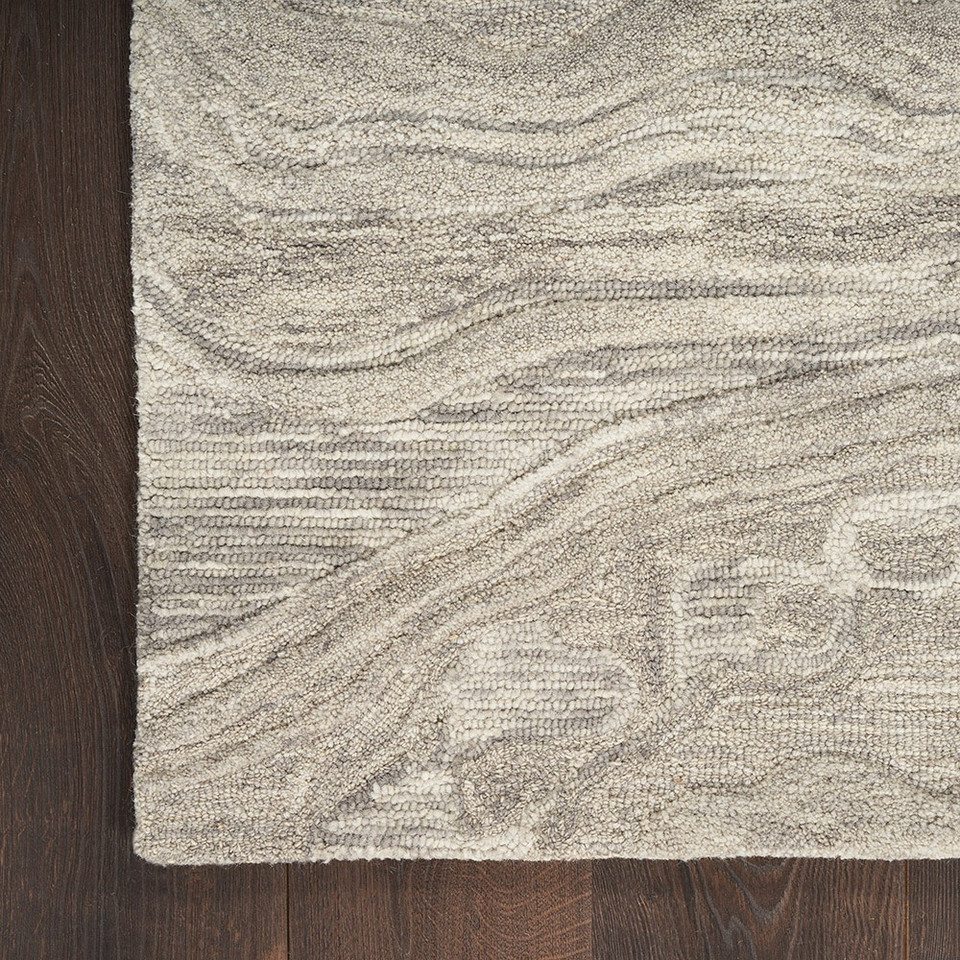 grey abstract rug closeup corner on wood floor