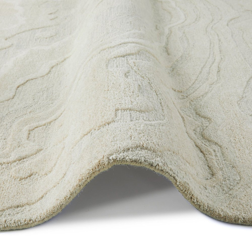 ivory abstract rug closeup folded on white background