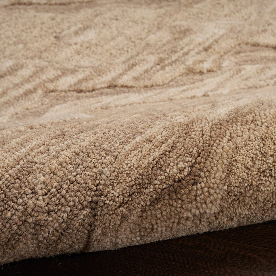 taupe abstract rug closeup partially rolled