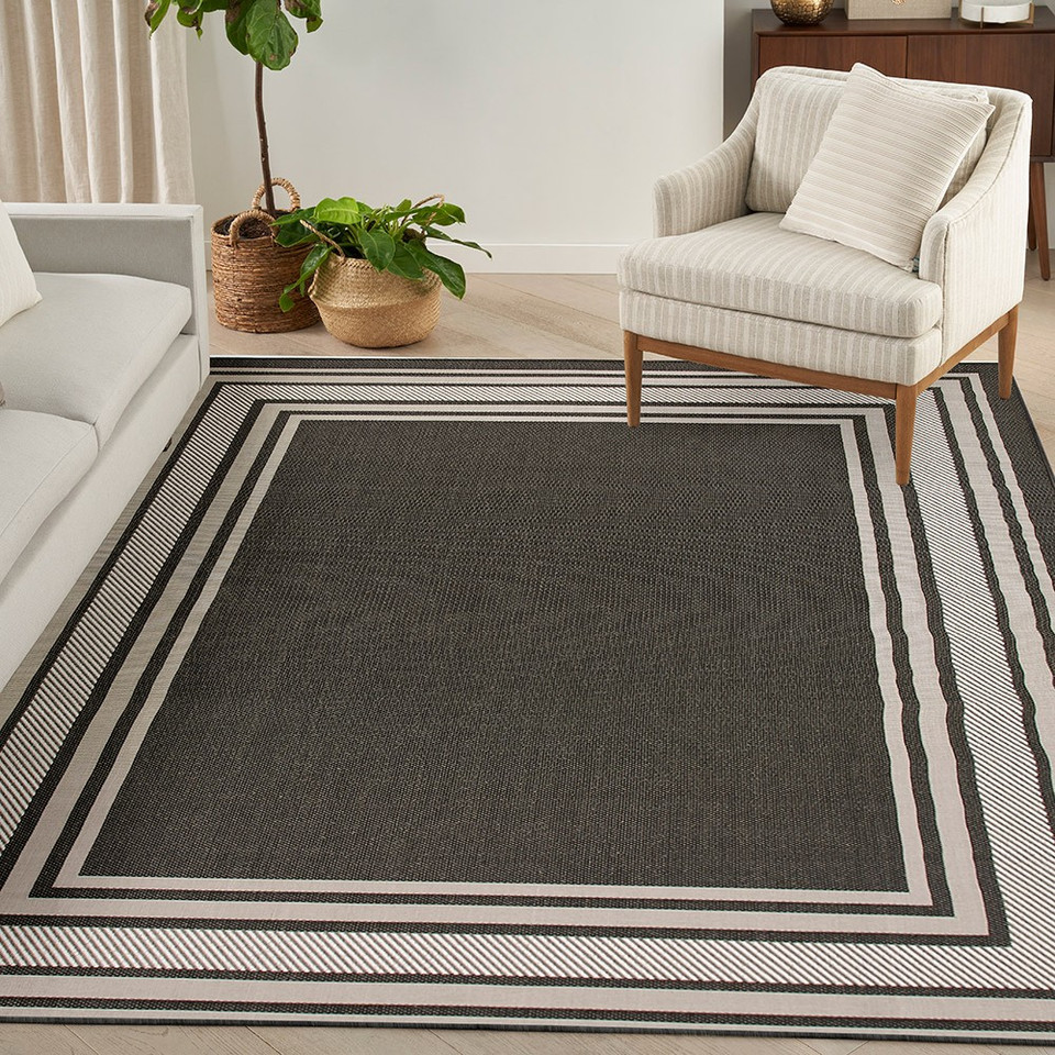 black geometric indoor outdoor rug in a room