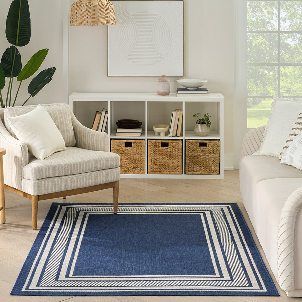 navy geometric indoor outdoor rug in a room