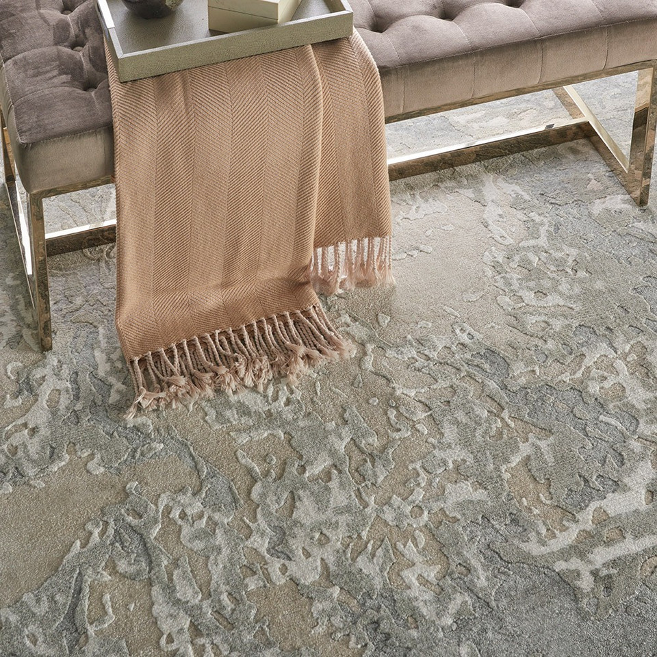 sand abstract rug closeup with bench and scarf