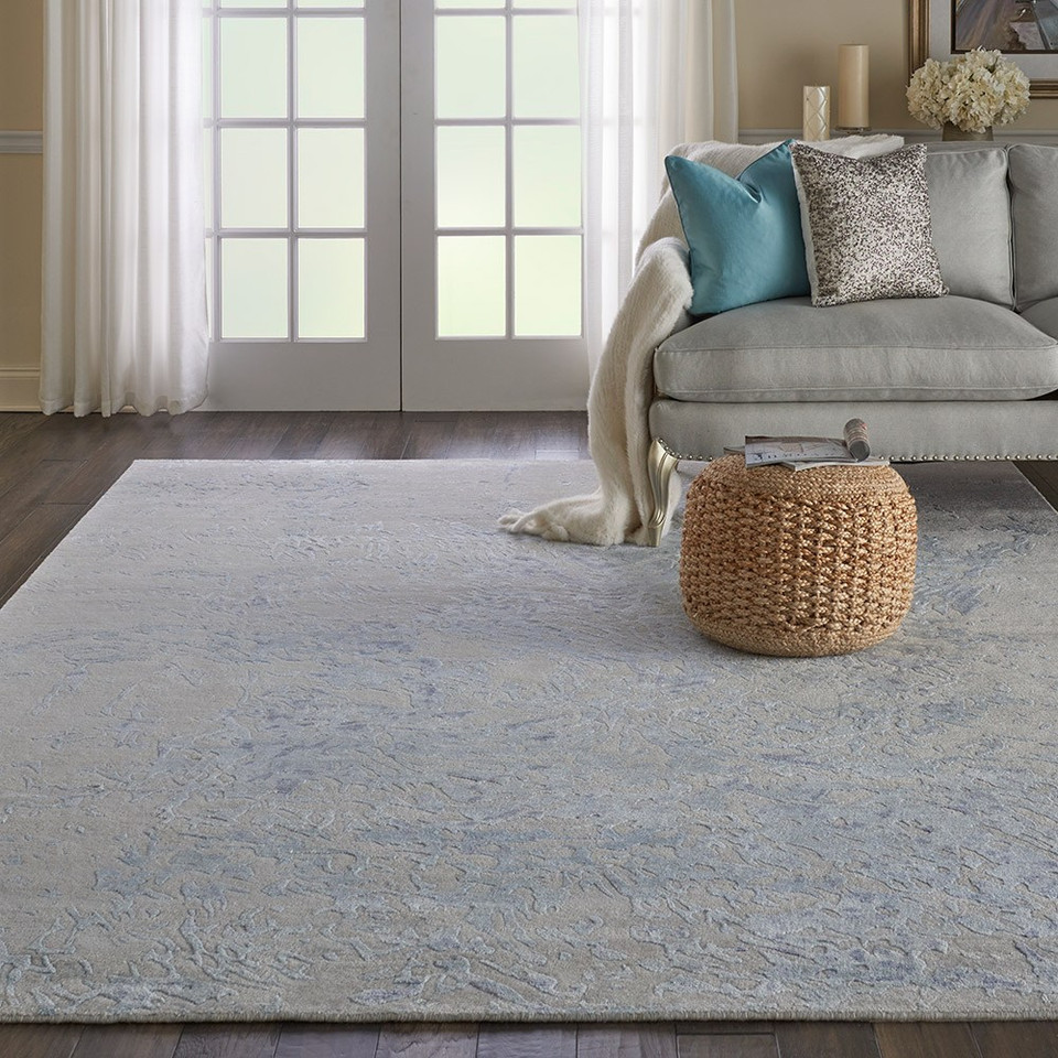 grey blue abstract rug in a room with matching decor