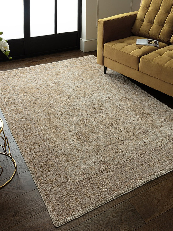 beige traditional rug in a living room with matching decor 