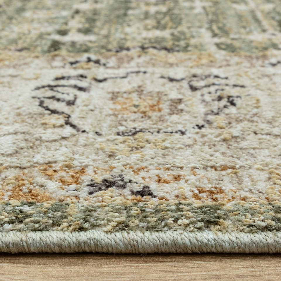 green traditional rug edge on wood floor