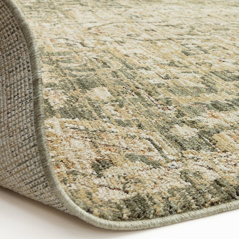 green traditional rug partial fold on white floor